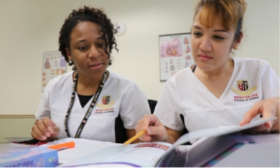 Two nursing students study together in a learning center on their Jersey College campus.