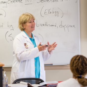 Teacher in front of white board